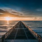 empty dock at the beach during golden hour